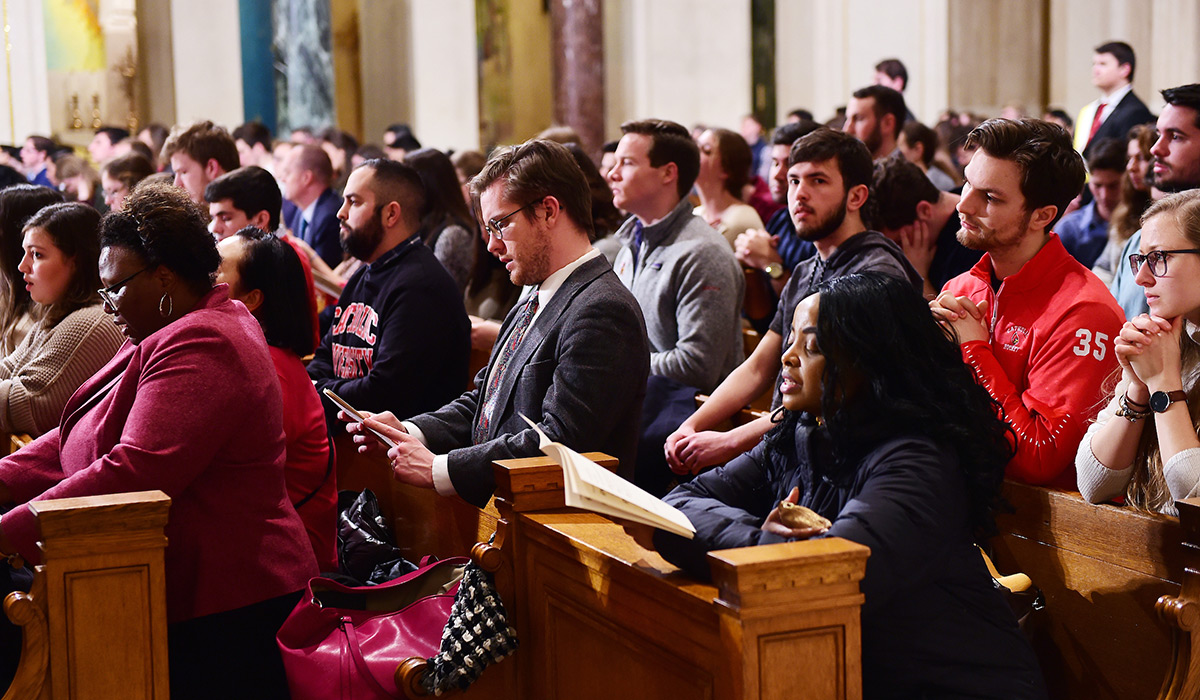 People in prayer at 2020 Mass of St. Thomas Aquinas