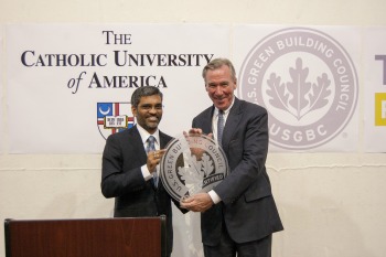President Garvey receives the LEED Certified plaque from Ramanujam
