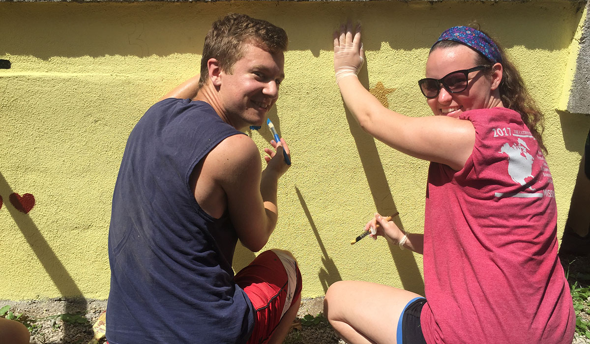 Students painting a wall