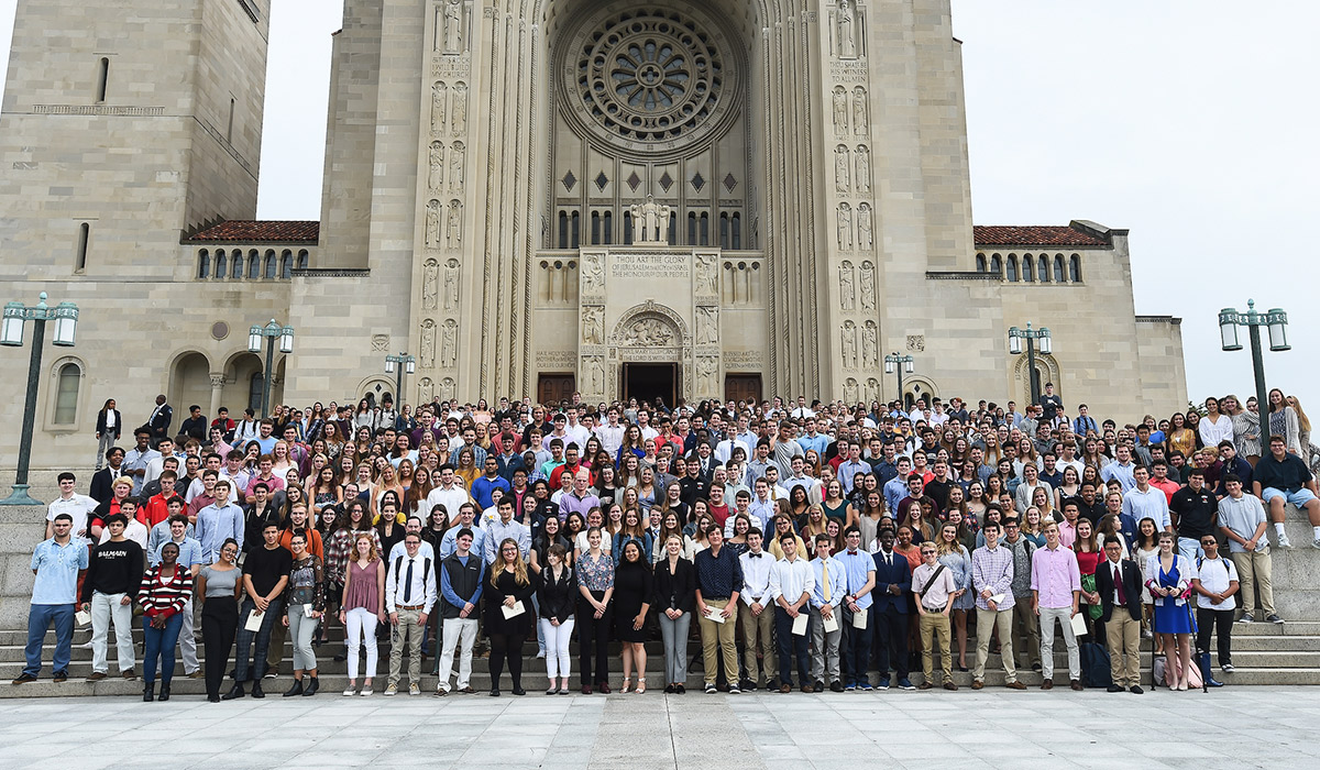 Students of the class of 2022 stand outside the Basilica of the National Shrine of the Immaculate Conception for a group photo