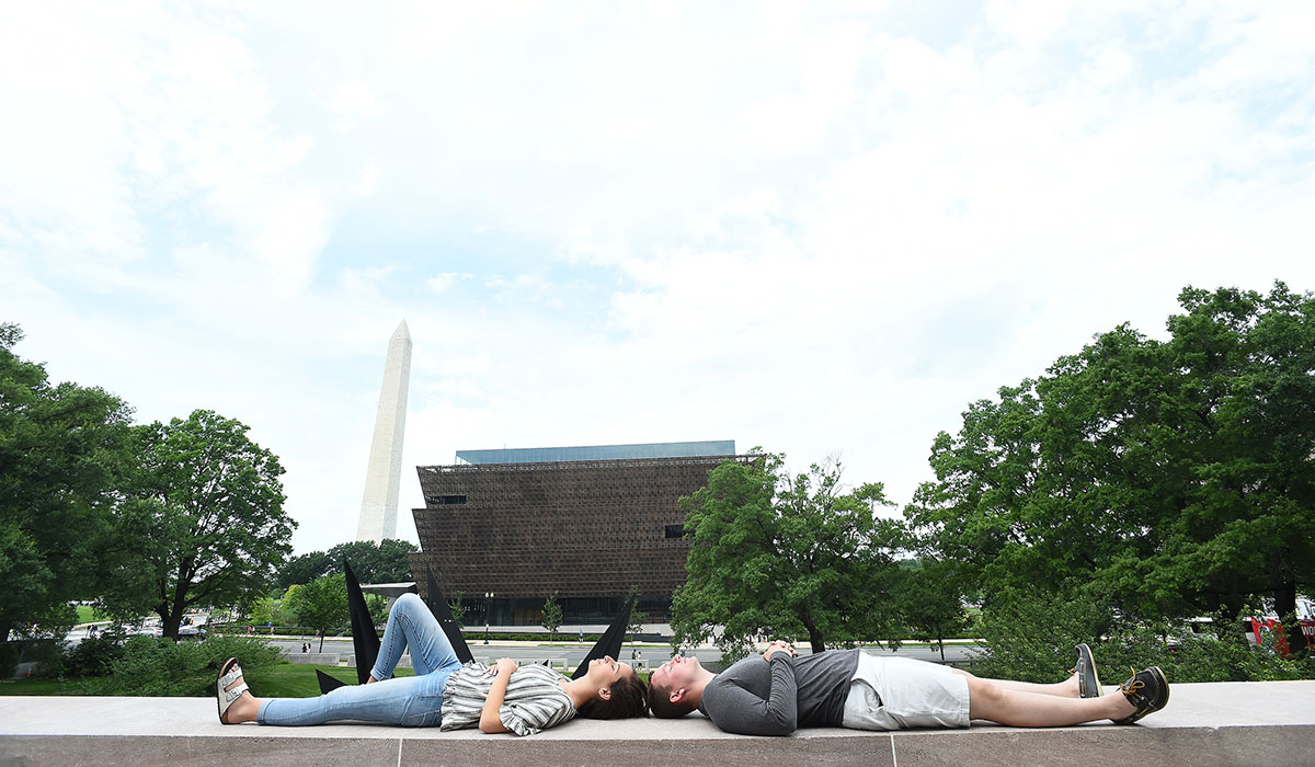 Students laying down in front of museums 