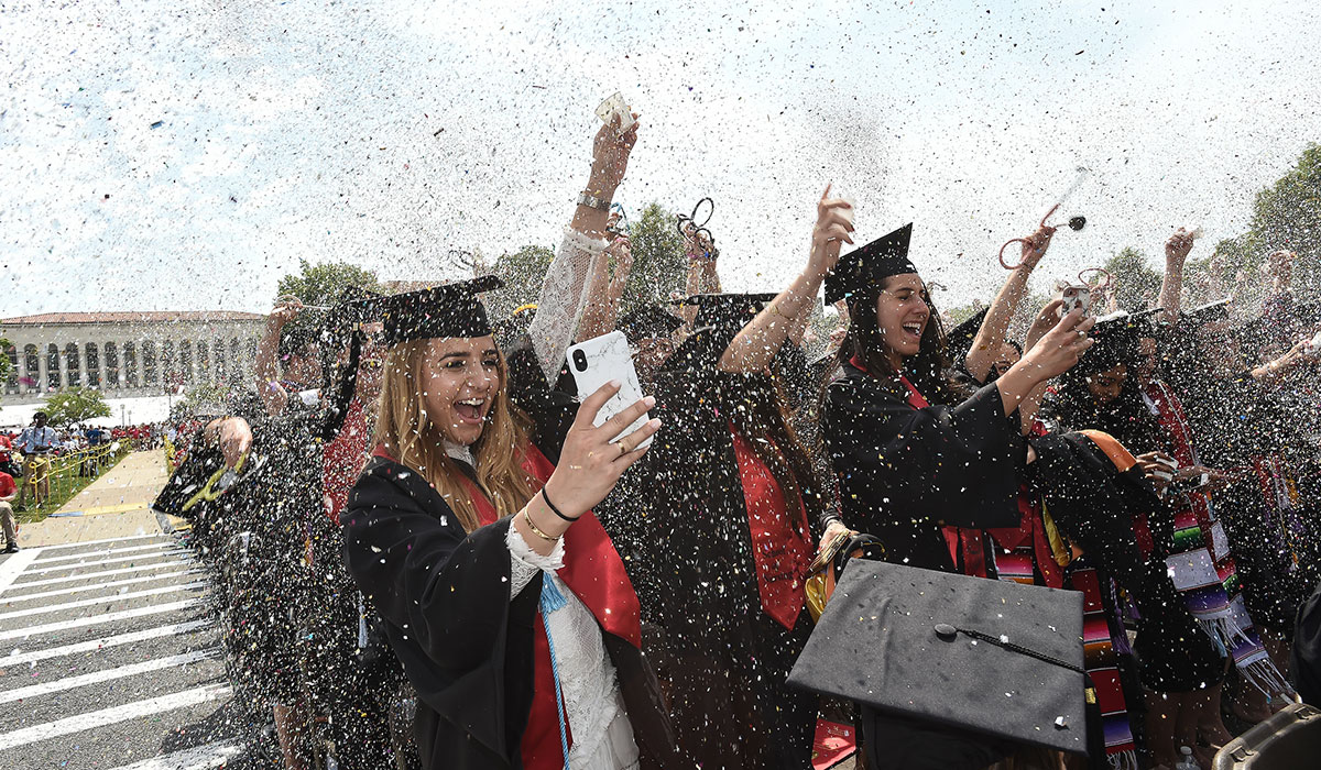 Students throwing confetti at Commencement 