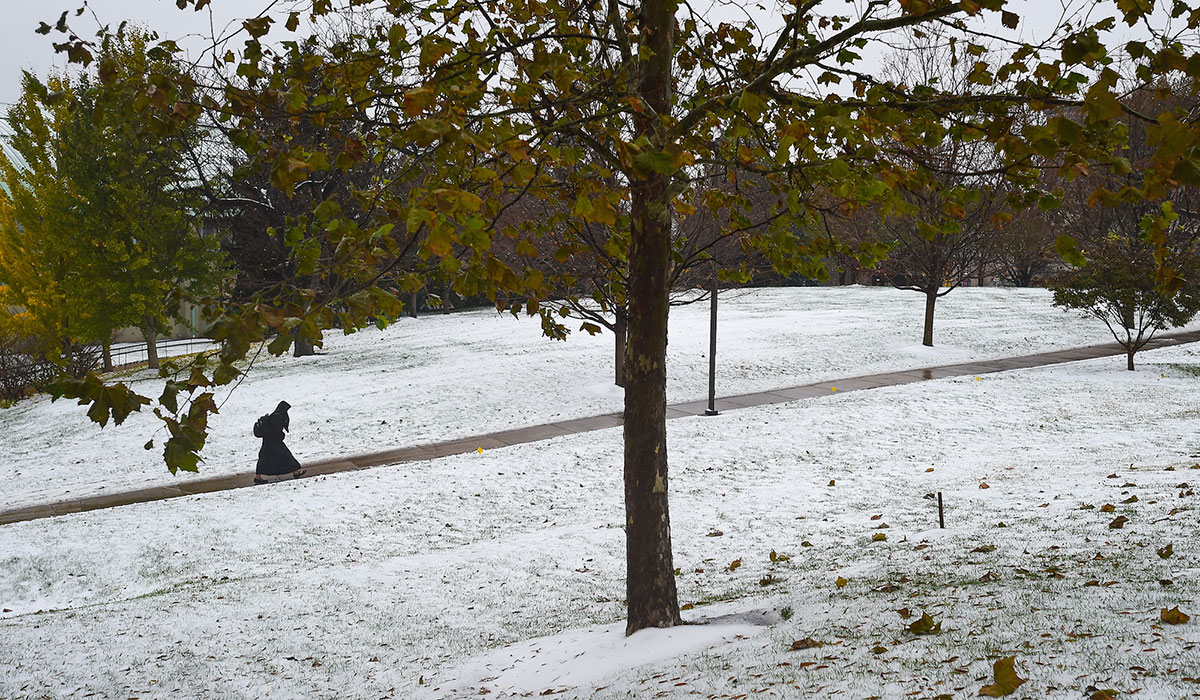 Nun walks through snow on campus