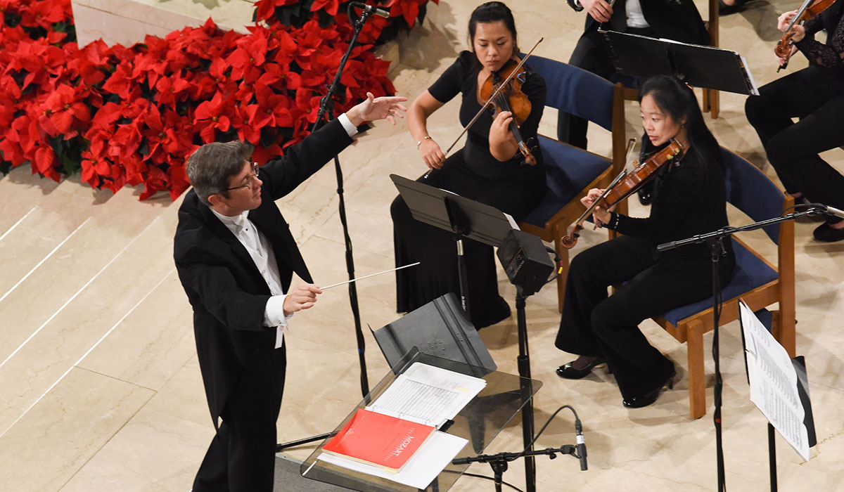 Conductor and musicians performing