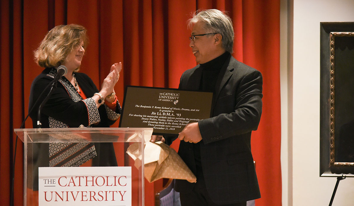 Jacqueline Leary-Warsaw presents Jie Li with a plaque