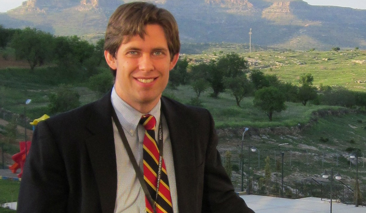 Assistant Professor Aaron Butts standing for a photograph