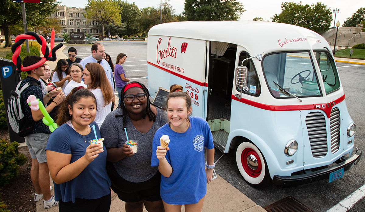 Students eating Ice cream from food trucks at cardinal festival