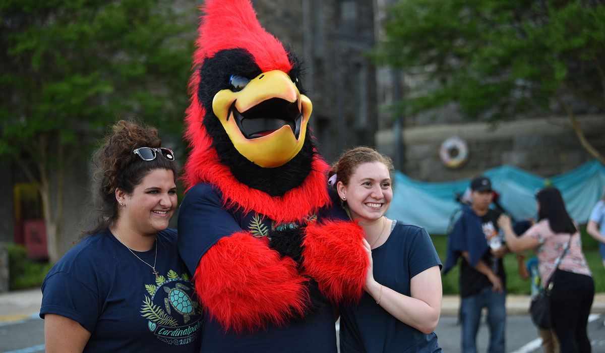 Students posing with Red the mascot