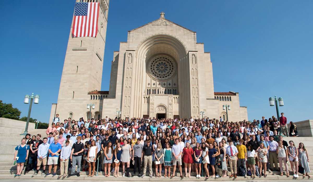 The Class of 2023 poses for a group photo on the steps of the Basilica of the National Shrine of the Immaculate Conception