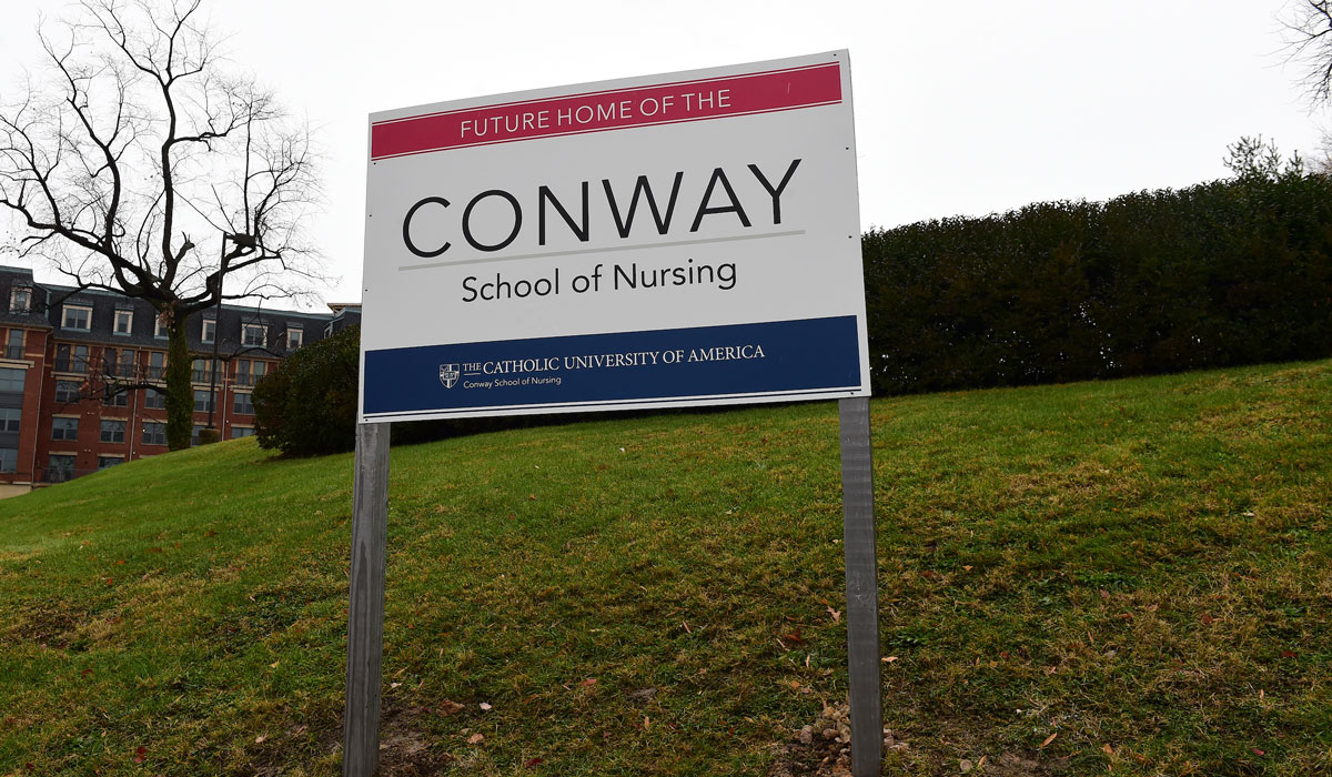 Conway sign on hill next to site of new building