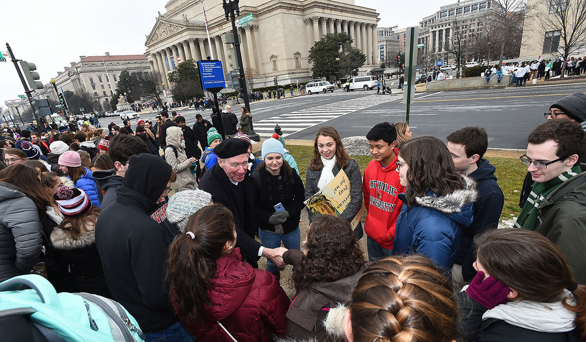 President John Garvey shakes hands with students during March for Life
