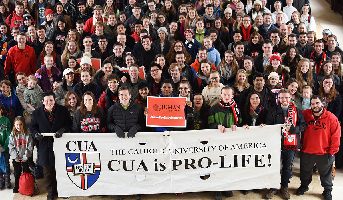 Students posing with Catholic University pro-life banner