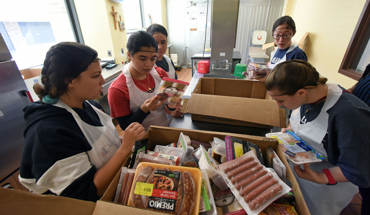 Students sorting through other boxes of food