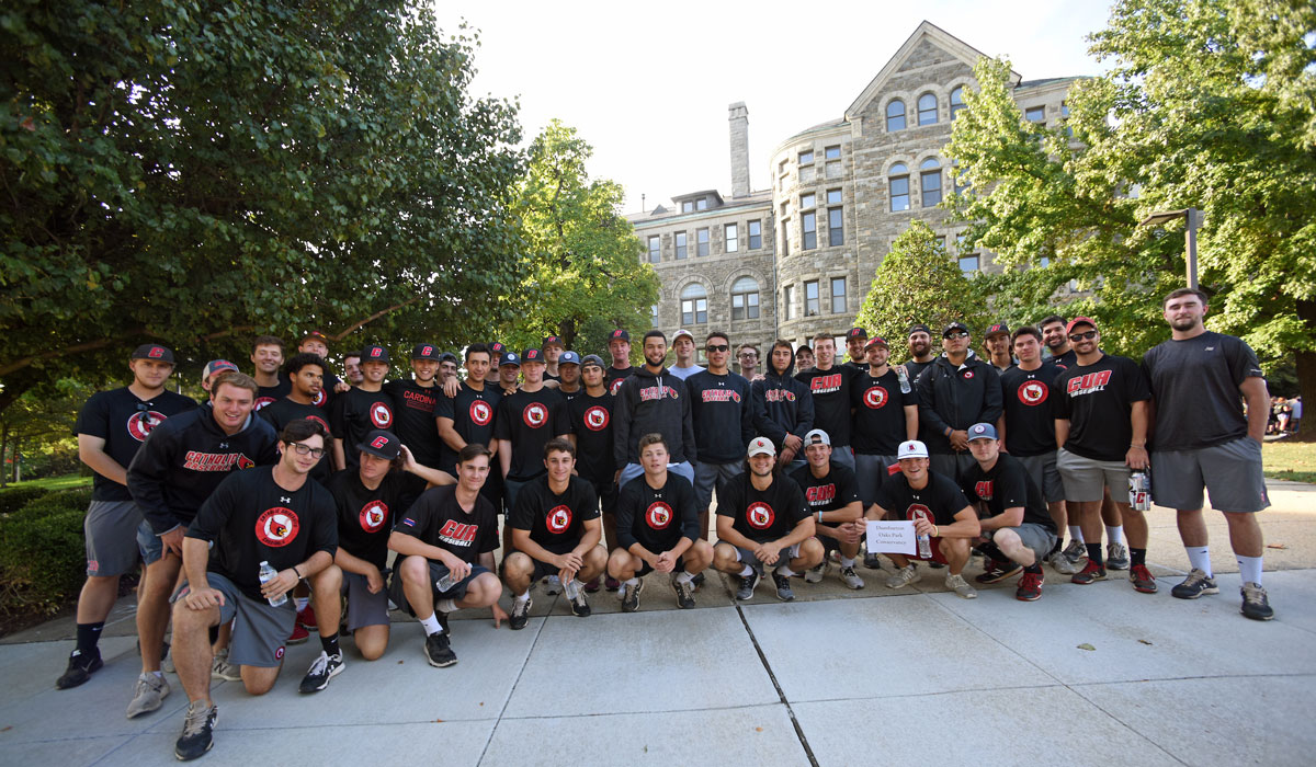 Male sports team gathers for group photo before heading to volunteer spot