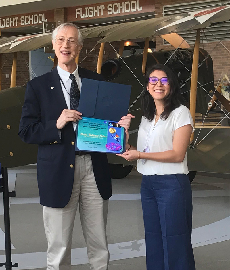 Stela Ishitani Silva accepting an award at NASA