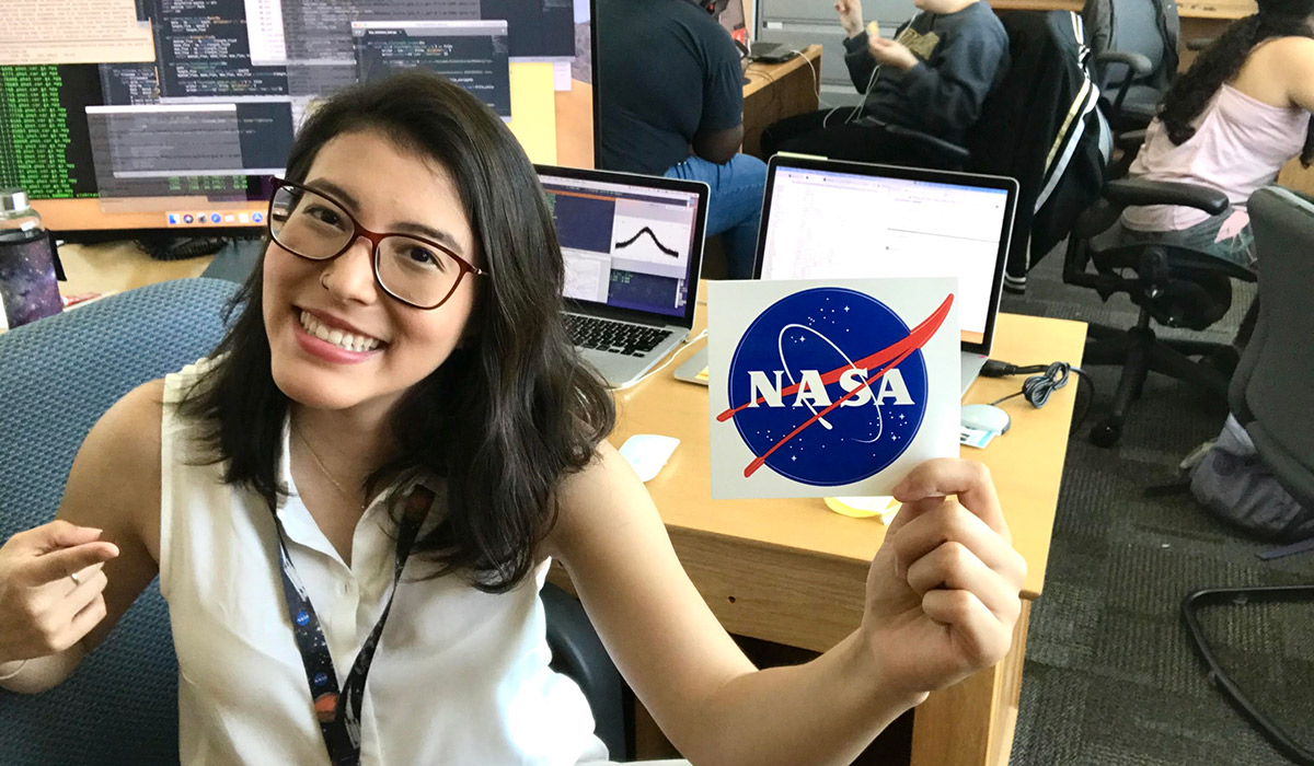 Stela Ishitani Silva holding a NASA sticker