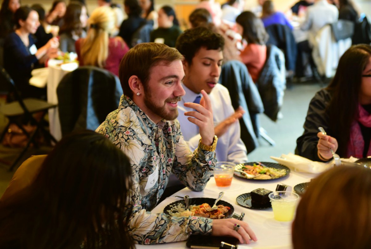 Male student chatting at the luncheon 