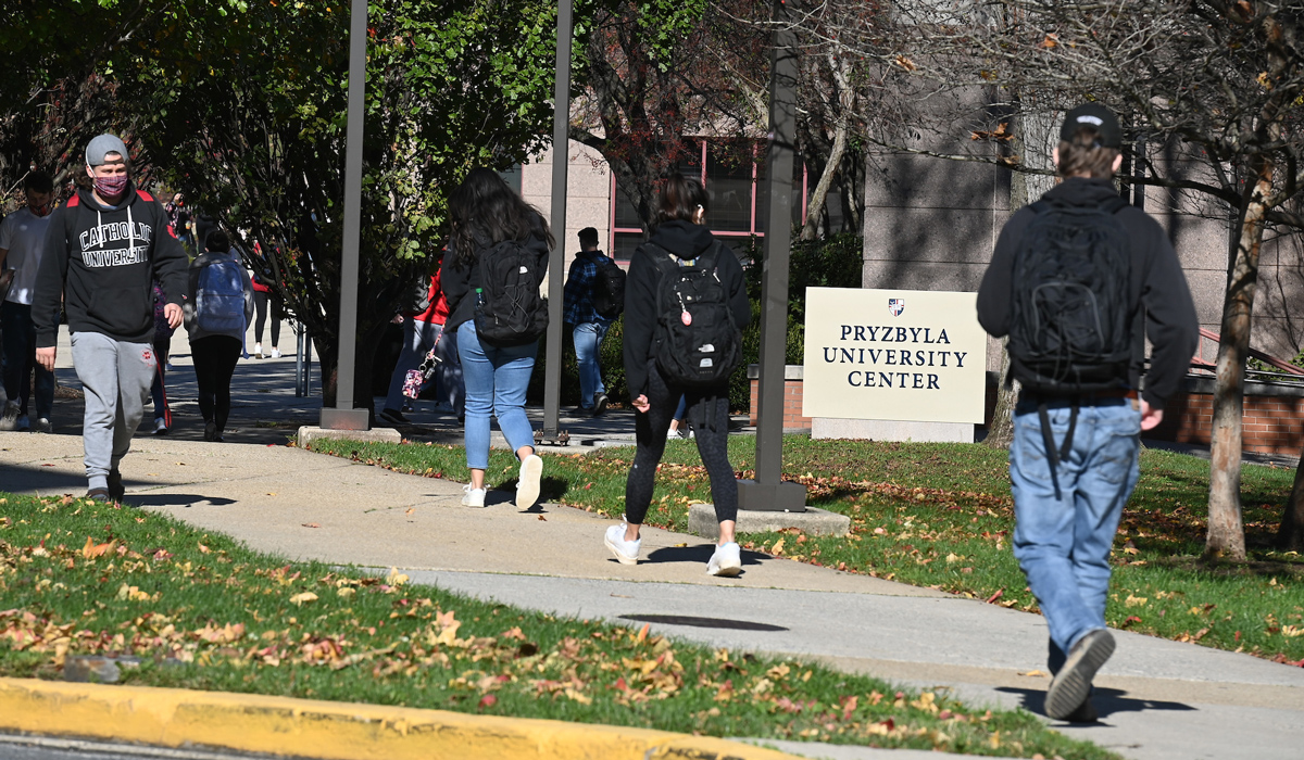 Studenty walking along campus sidewalks