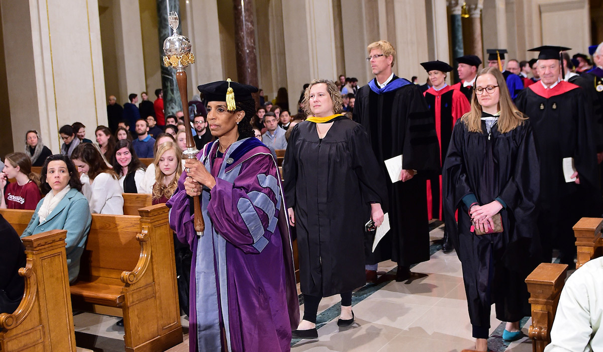 Faculty members process down the aisle