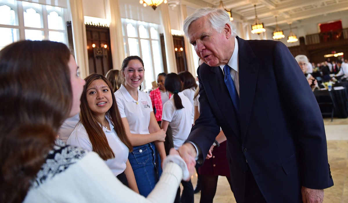 Bill Conway shaking hands with nursing students