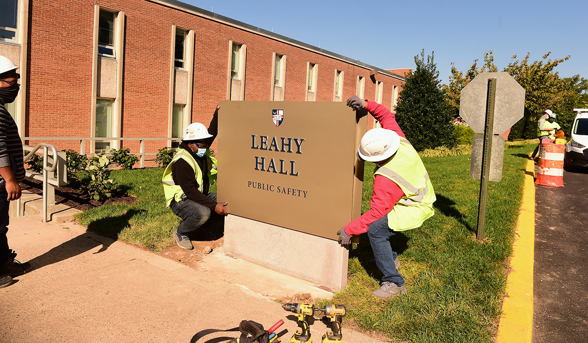 A sign being installed outside Leahy Hall