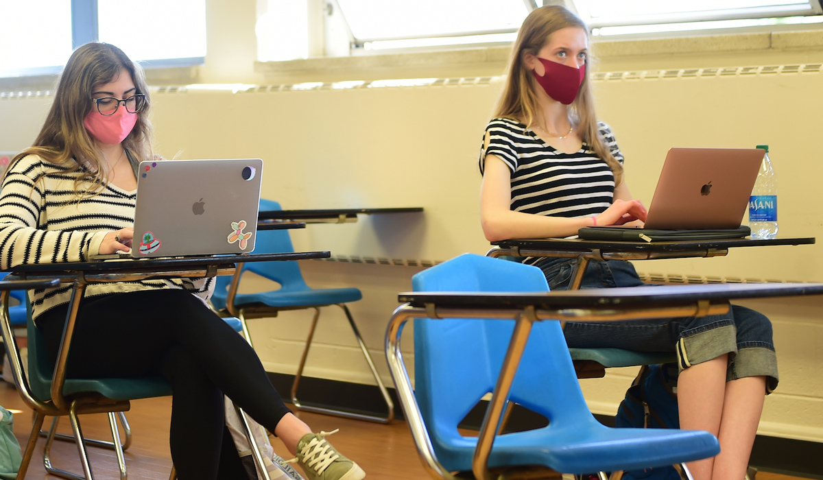 Students wearing masks and sitting in a classroom 