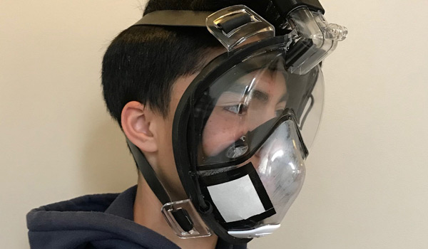Young man modeling a reusable surgical mask