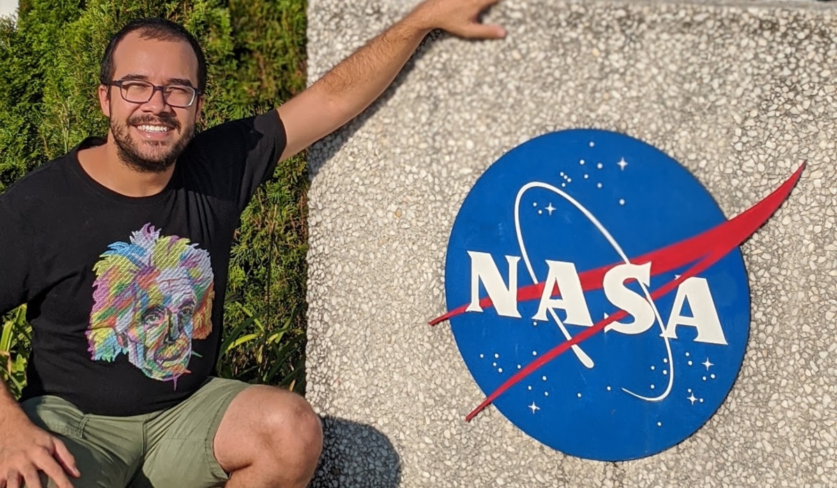 Guedes dos Santos in front of a NASA sign