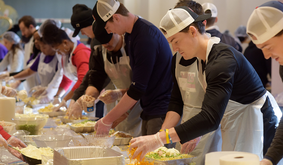 Students volunteering by making meals