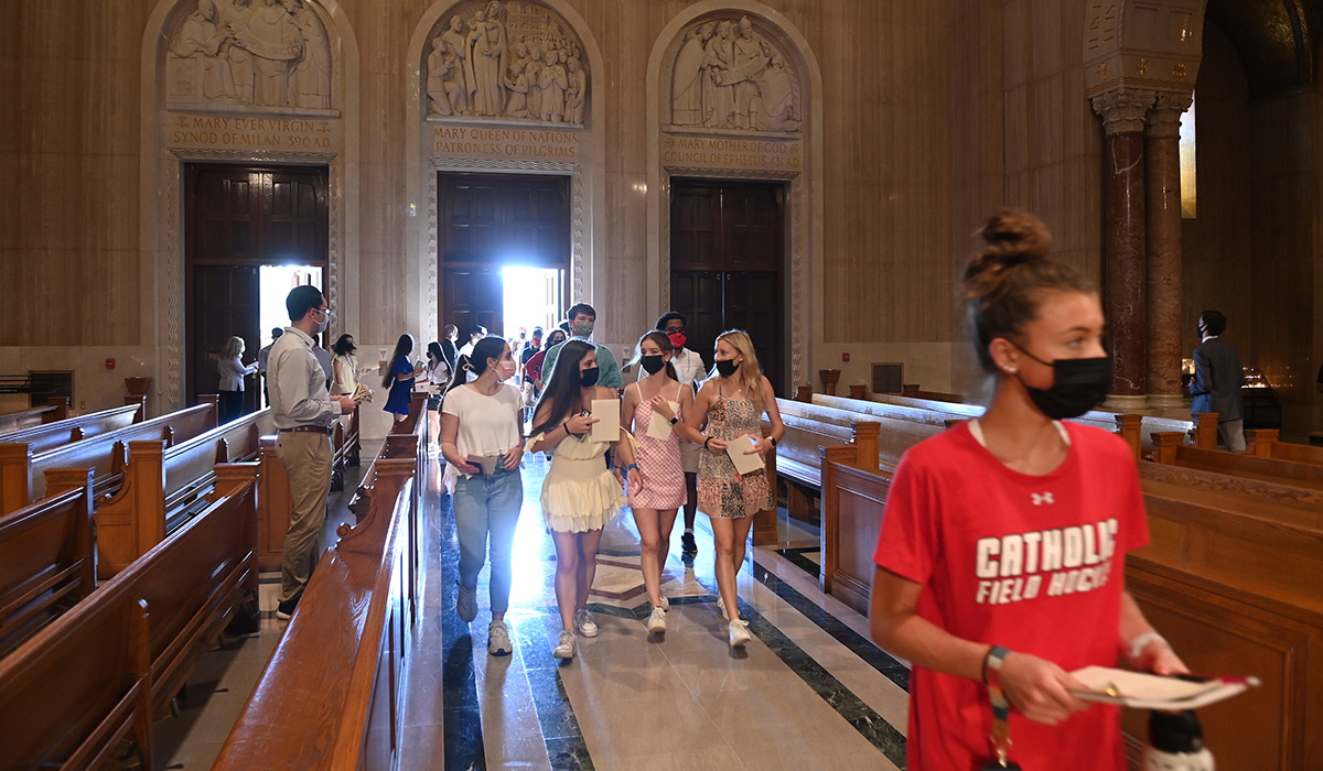 Students walking toward pews in Basilica