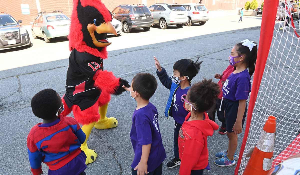 Children meeting Red the Cardinal mascot