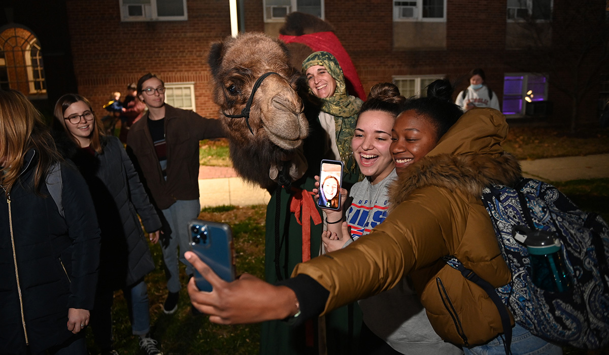 Students pose with camel