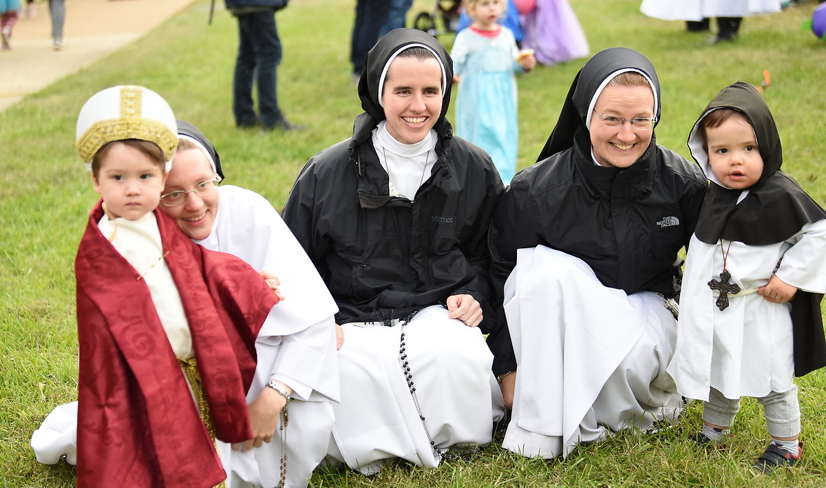 Children pose with Dominican Sisters at Halloween on Campus