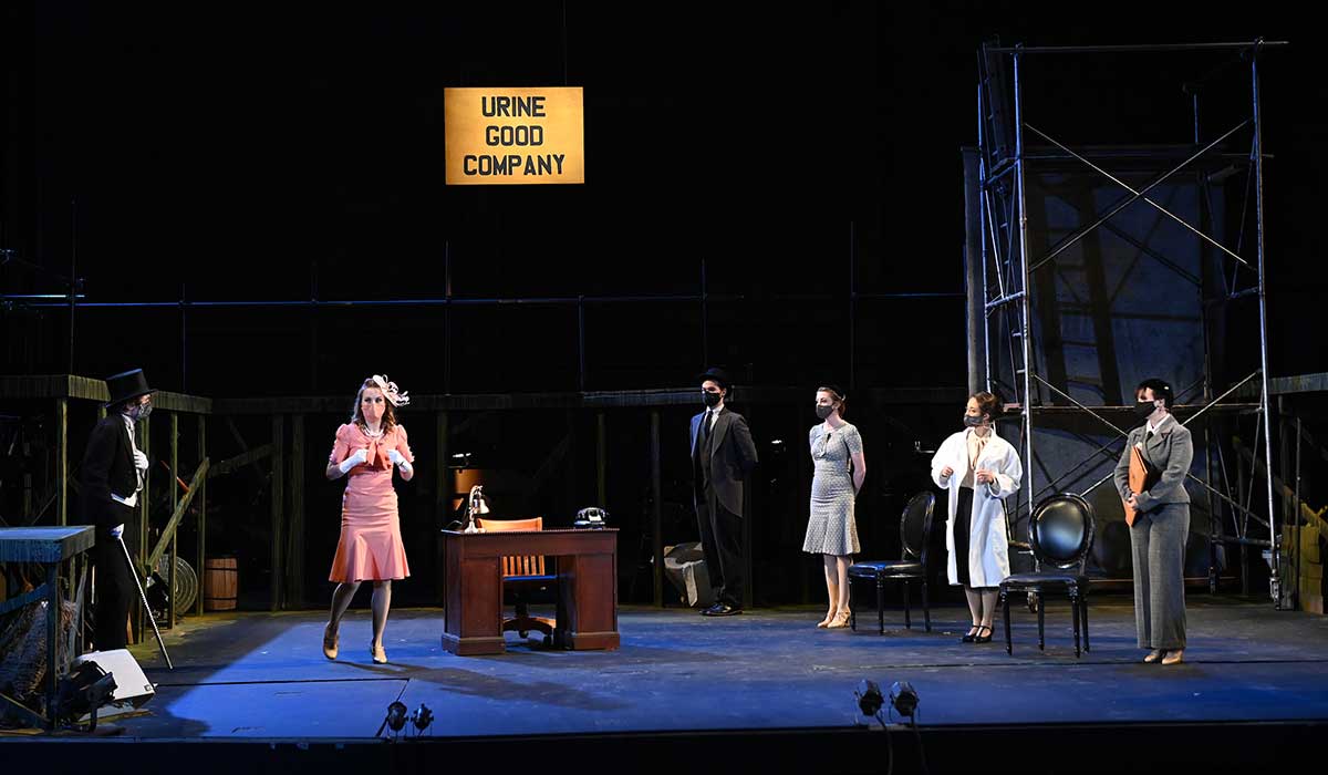student performing in urinetown