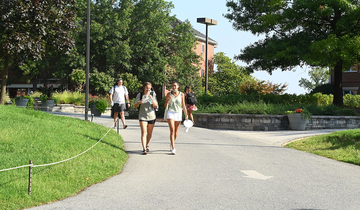 Two female students walking near residence halls