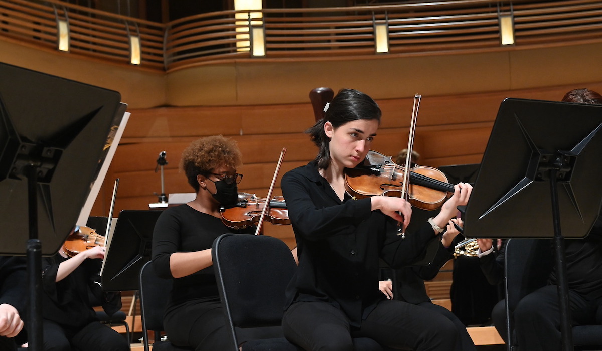 A student plays the violin at the concert