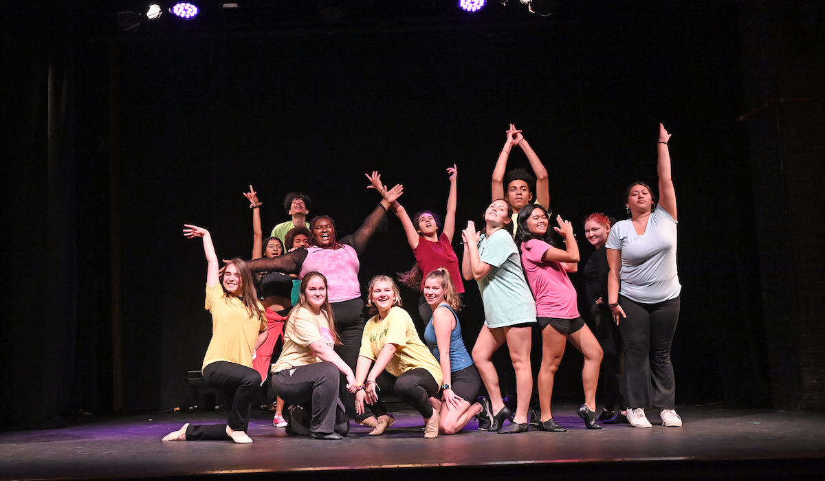 students pose for a fun photo in colorful shirts during the final dress rehearsal of the summer high school drama institute