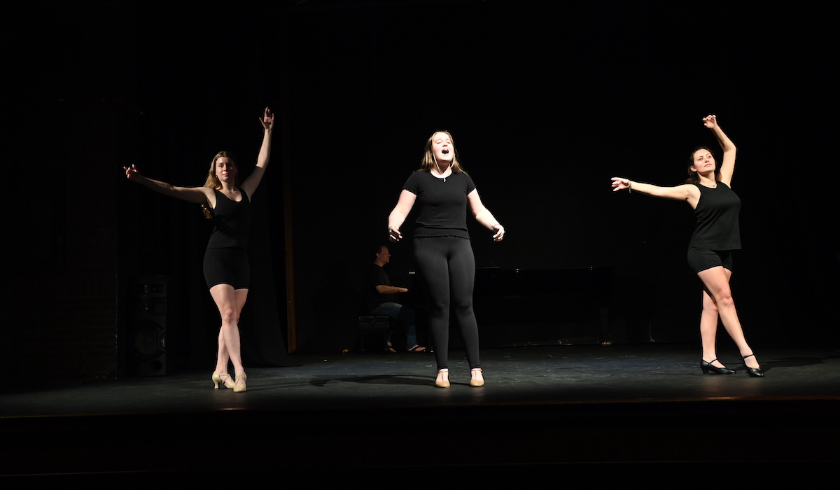 students performing on stage during the final dress rehearsal of the summer high school drama institute