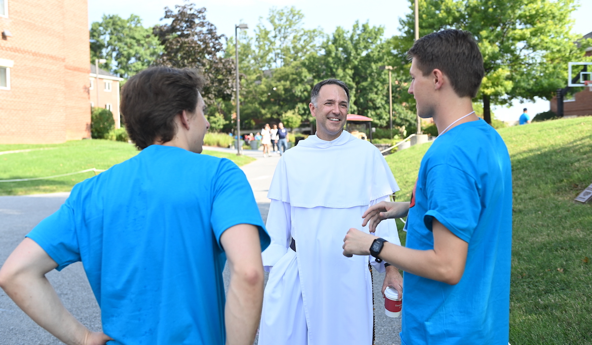 University Chaplain and Director of Campus Ministry Father Aquinas Guilbeau, O.P. chats with some Orientation Advisors