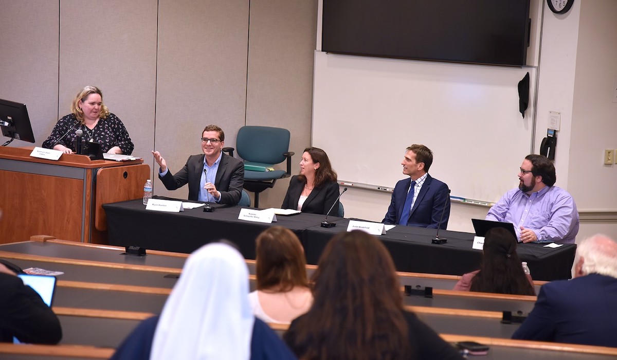panelists talk at the law school's event on adoption