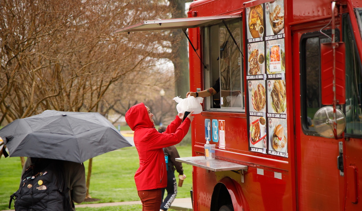 Student getting food from a food truck at research day