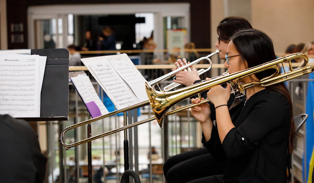 Trombonists from the CUA Symphony Orchestra perform in the pryz during research day