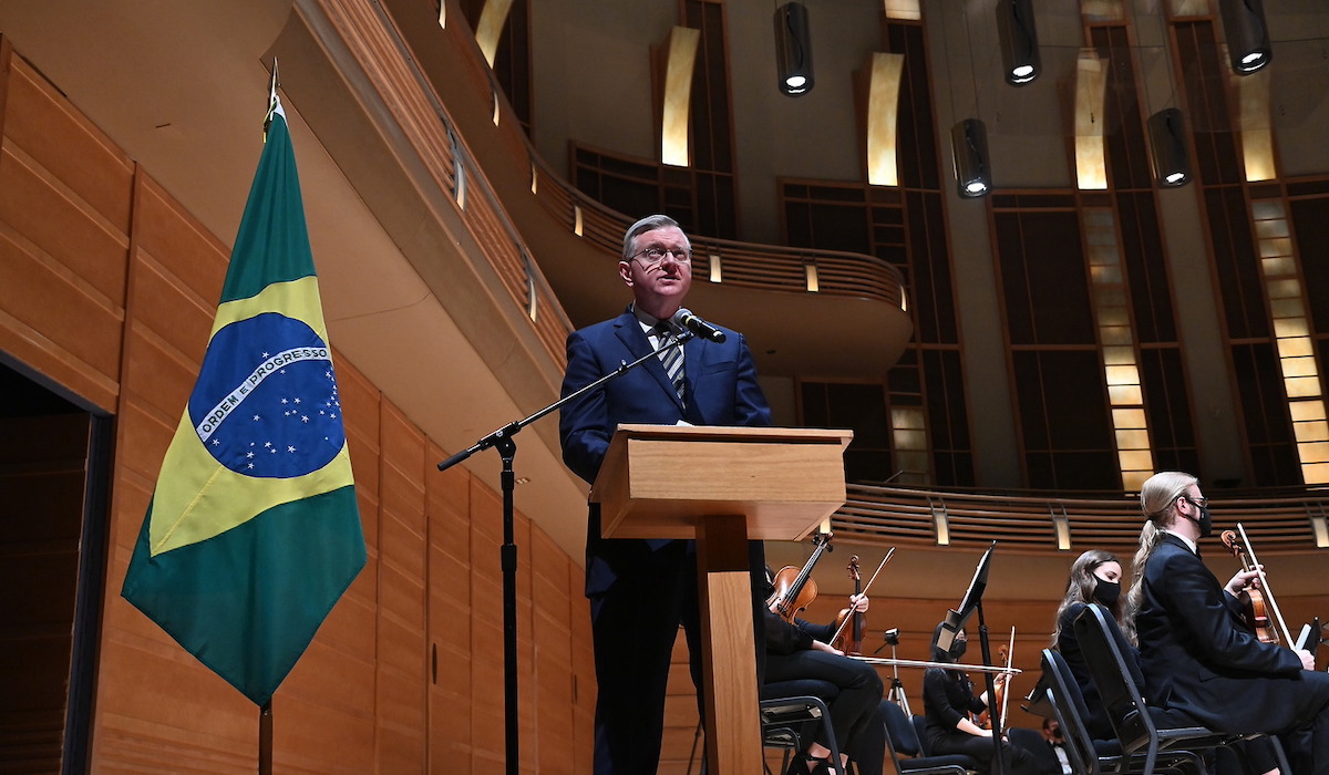 Nestor Forster, Jr., ambassador of Brazil to the United States, gives remarks on stage at the concert
