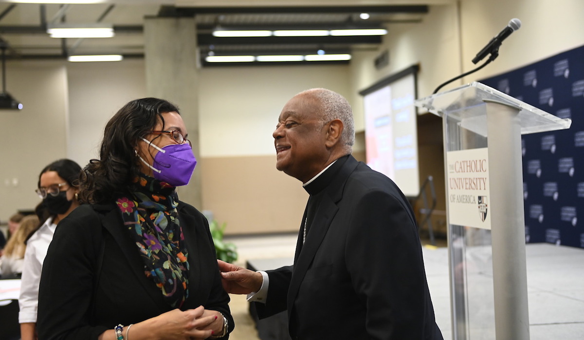 Cardinal Gregory talks with a member of the university community