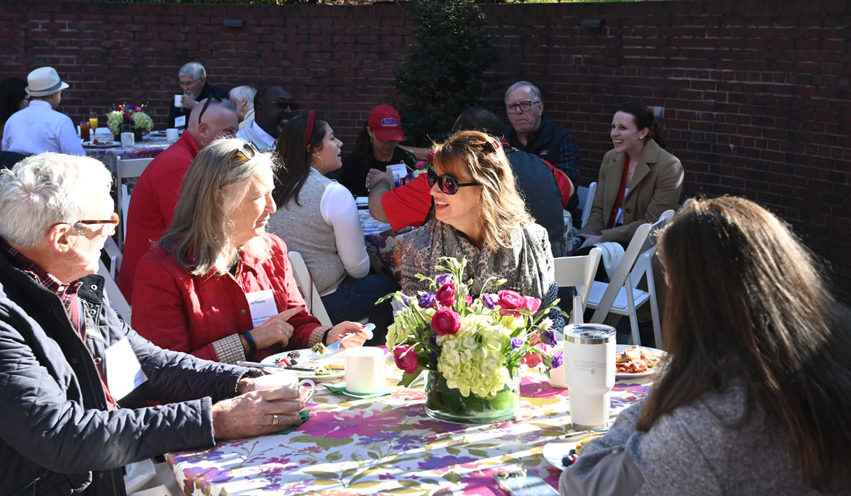 Alumni and board members catch up at President’s Leadership Breakfast on Saturday, Oct. 22