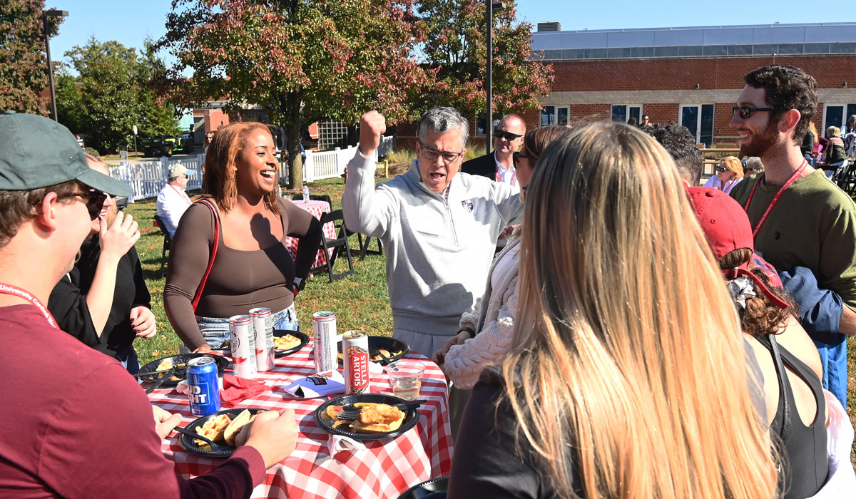 President Kilpatrick shows alumni his Cardinal spirit before the Homecoming football game on Saturday