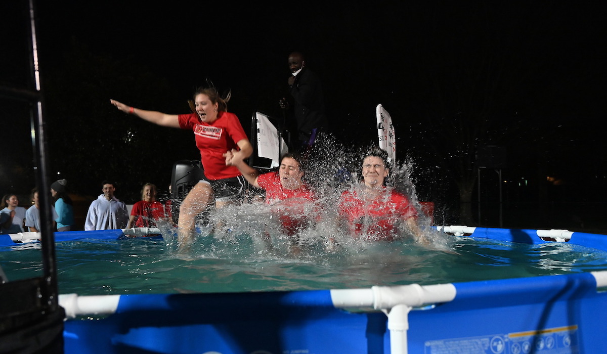 Three girls splashing into the polar plunge pool together