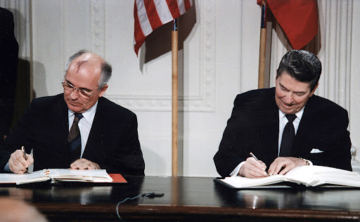 President Ronald Reagan signing a document