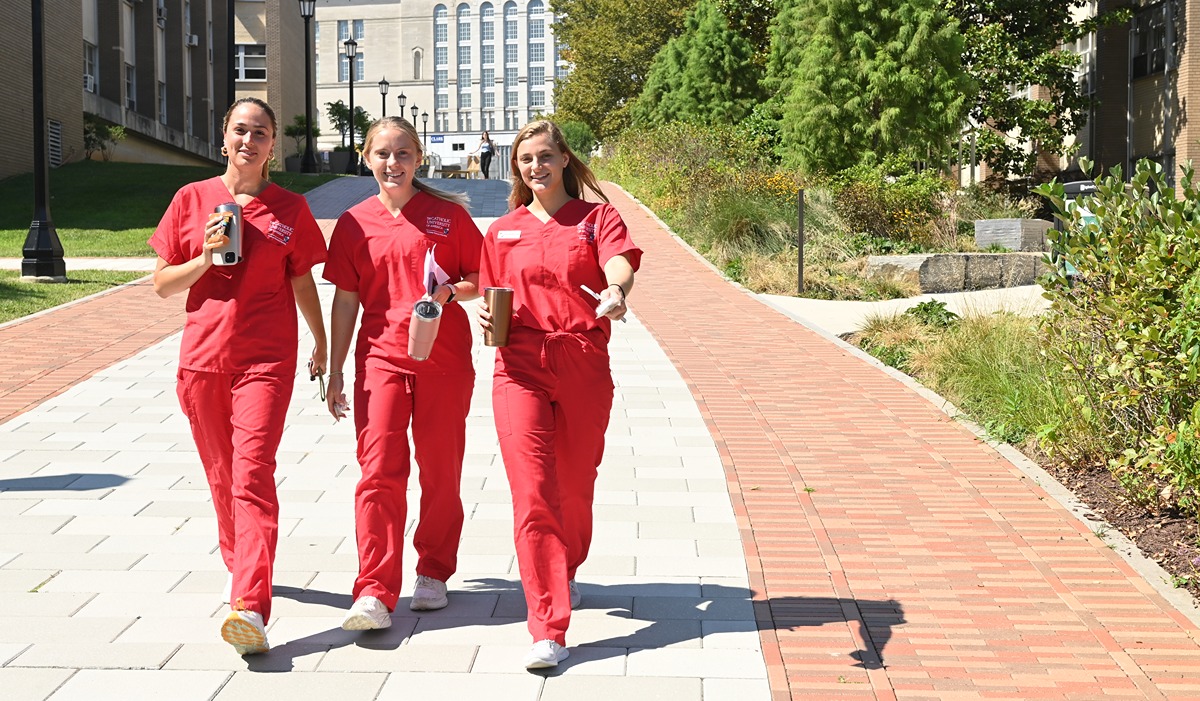 Nursing students from Catholic University walk on campus.