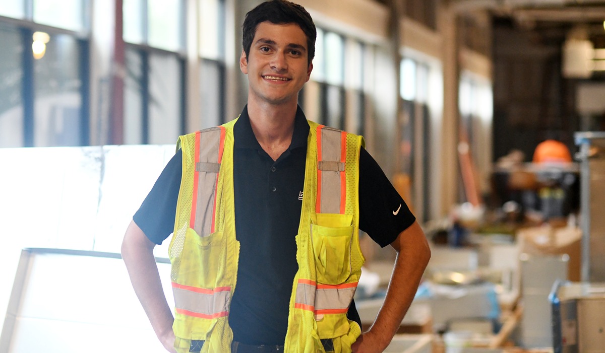 Andrew Mitchell in a construction vest at a construction site